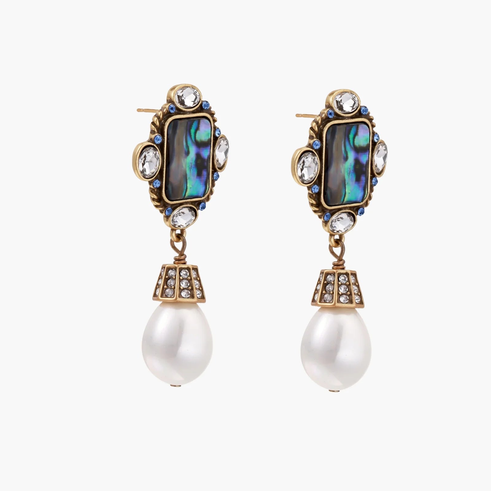 Ornate gold-plated earrings with iridescent abalone shell, crystals, blue stones, and white pearl drops on cream background.
