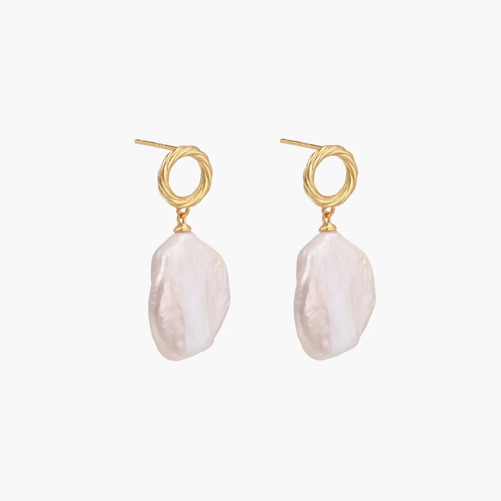 18K gold vermeil twisted circle studs with organic white baroque pearl drops on cream background
