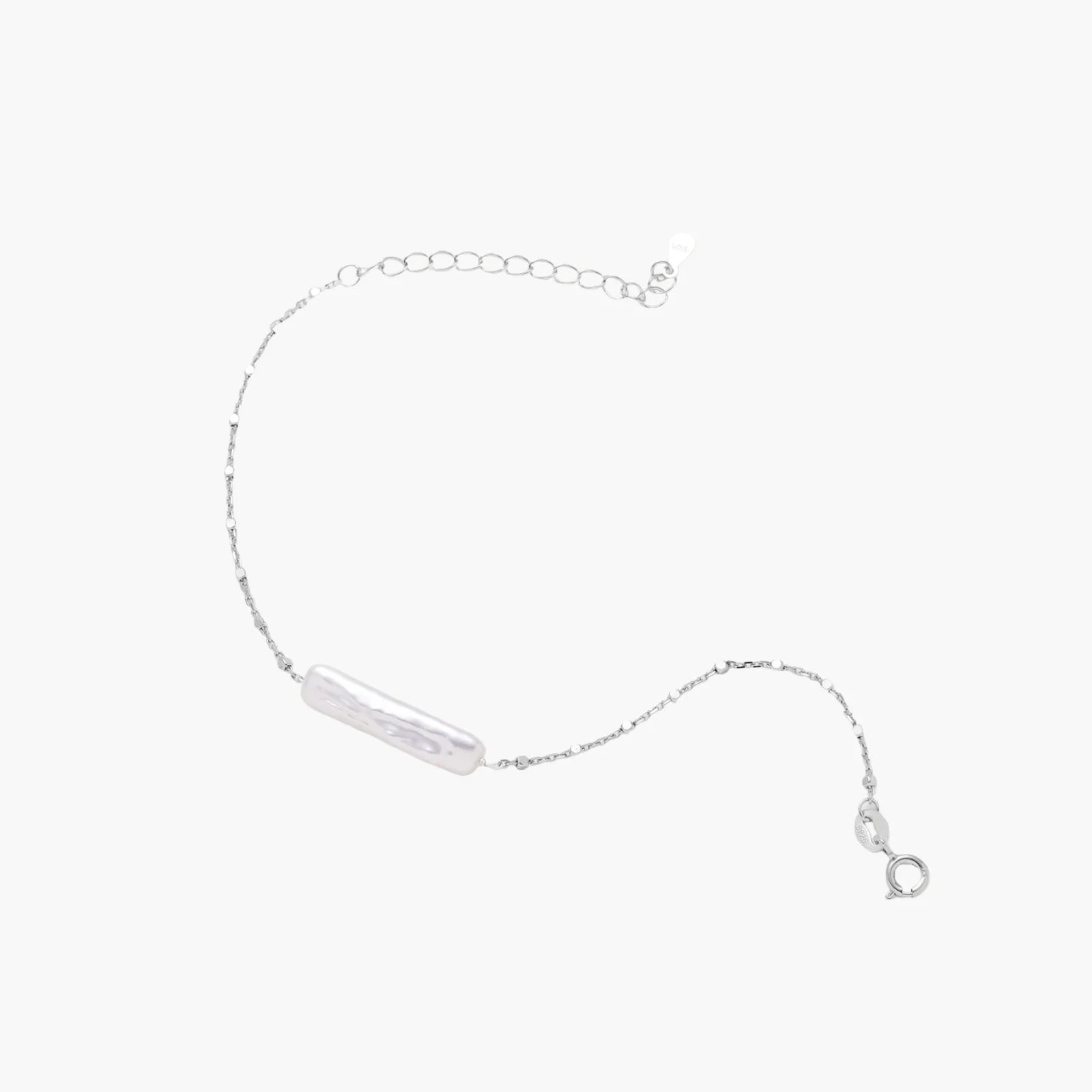 Minimalist bracelet with iridescent baroque pearl on rhodium-plated sterling silver chain against cream background