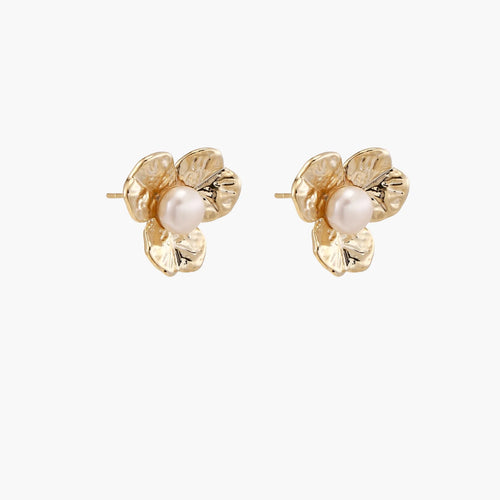 Gold-plated flower stud earrings with textured petals and centered freshwater pearl on beige background