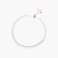 Double-wrap lavender beaded bracelet with rose quartz, pearls, gold vermeil charm and pink tassel on white background.