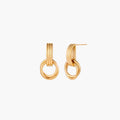Gold stud earrings with vertical ridged bar connecting to triple interlocking circular rings on white background