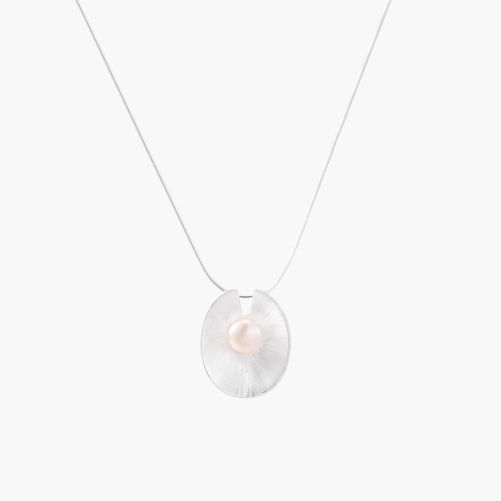 Sterling silver disc necklace with textured finish and centered freshwater pearl on delicate chain