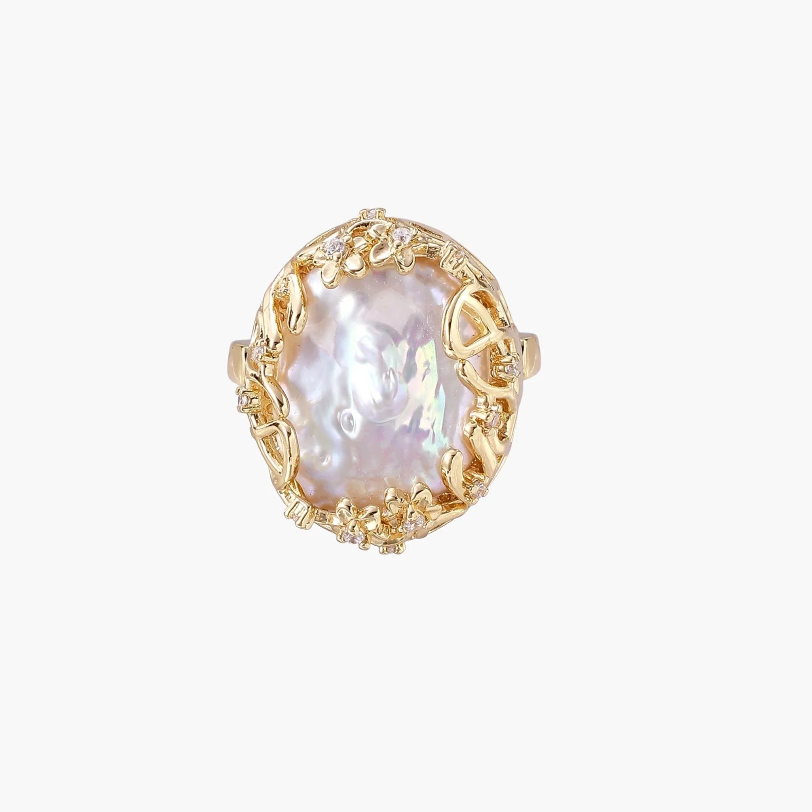 Gold filigree crown ring cradling an iridescent baroque freshwater pearl with crystal accents on white background