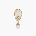 Iridescent shell brooch with gold bird accent and wire-wrapped baroque pearl drop on cream background.