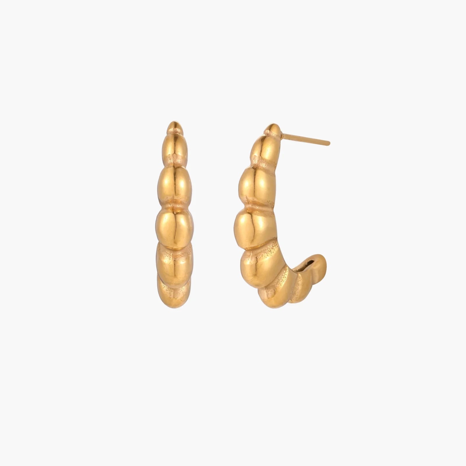 Gold-plated sculptural hoop earrings with chunky segmented design on cream background