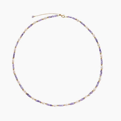 Delicate 18K gold vermeil necklace with alternating lavender zirconia beads and white freshwater pearls on cream background
