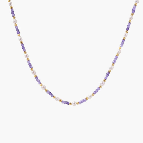 Delicate 18K gold vermeil necklace with alternating lavender zirconia beads and white freshwater pearls on cream background