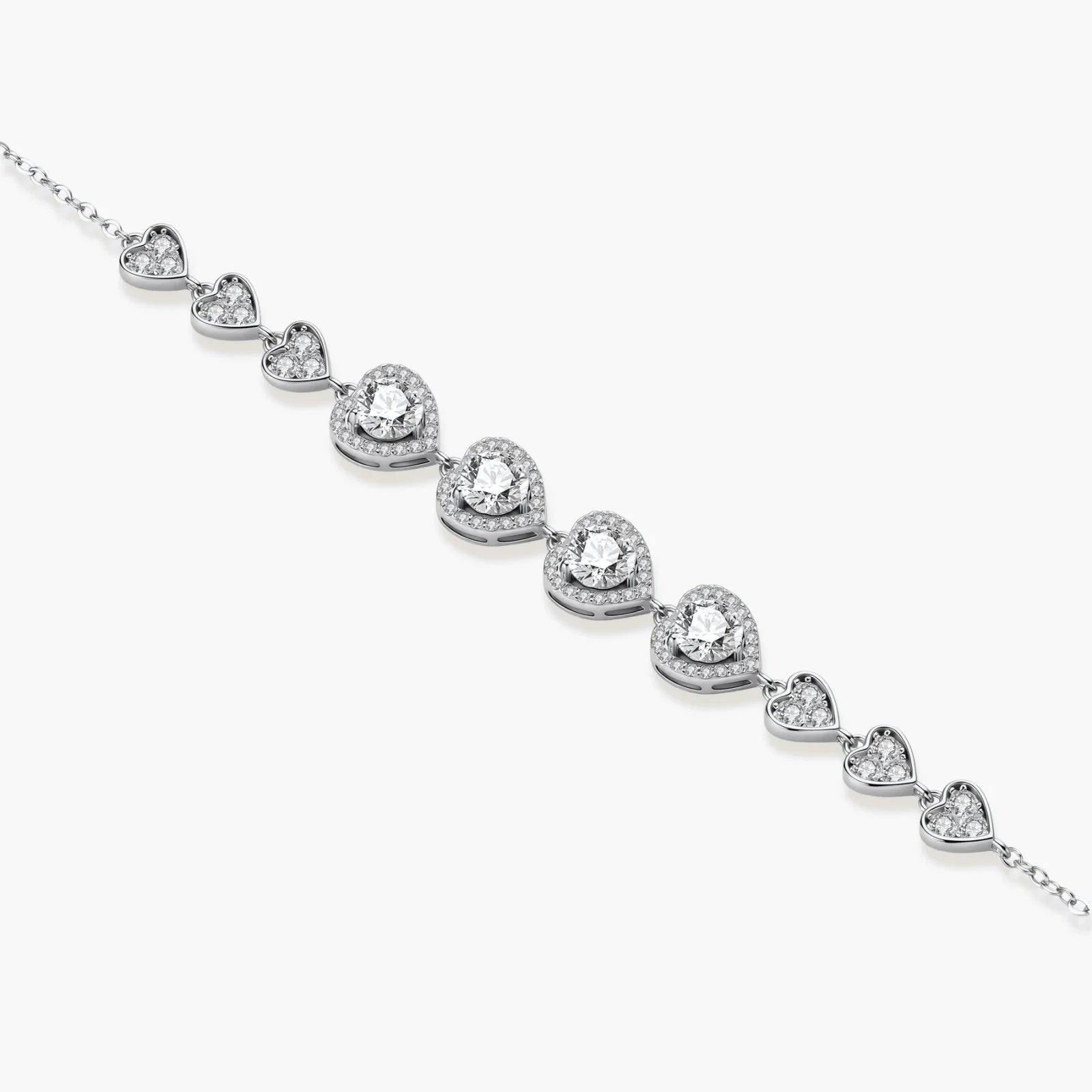 Sterling silver bracelet with graduated heart-shaped links and sparkling moissanite stones in VVS1 clarity on white background.