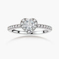 Heart-shaped halo ring with brilliant moissanite center stone surrounded by smaller crystals in sterling silver setting