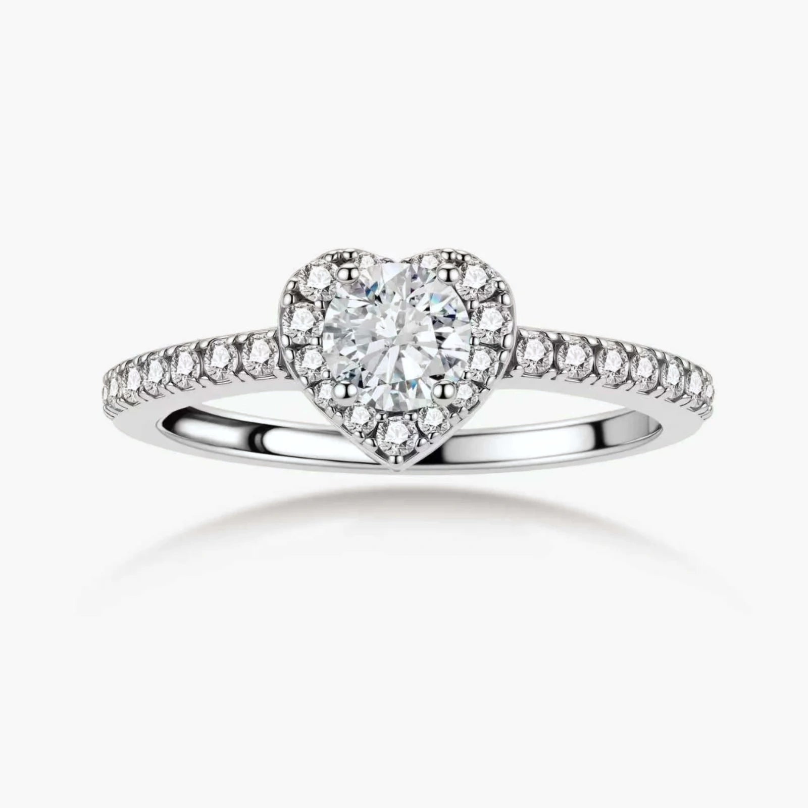 Heart-shaped halo ring with brilliant moissanite center stone surrounded by smaller crystals in sterling silver setting