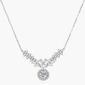 Elegant sterling silver necklace featuring intricate wing-like design with brilliant moissanite stones on neutral background.