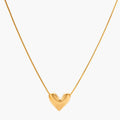 Dainty 18K gold-plated sterling silver necklace with small heart pendant on delicate chain against cream background.