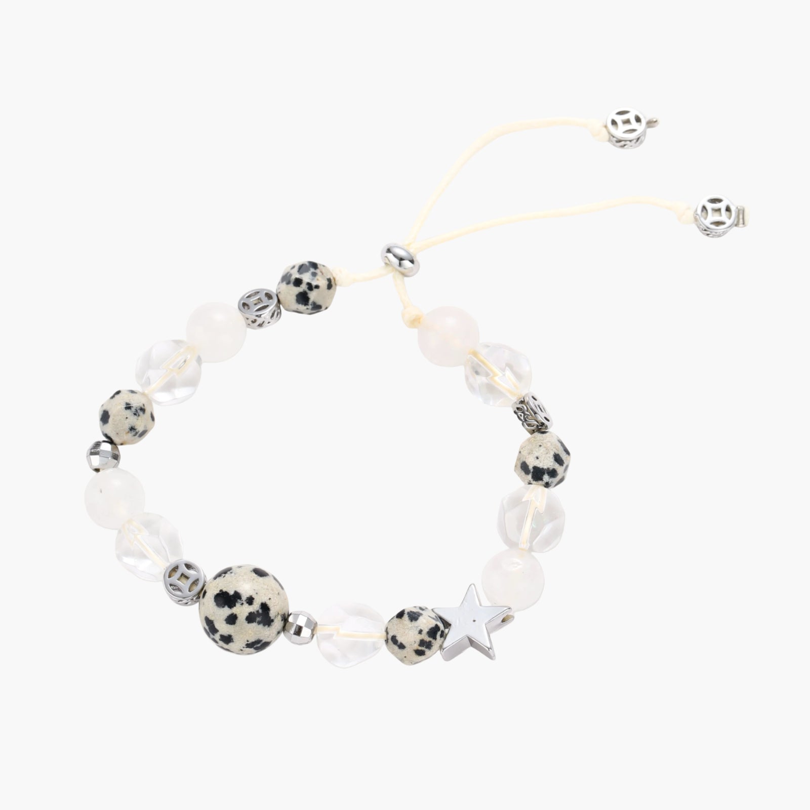 Adjustable beaded bracelet with spotted dalmatian stones, clear quartz crystals, and silver star charm on white background.