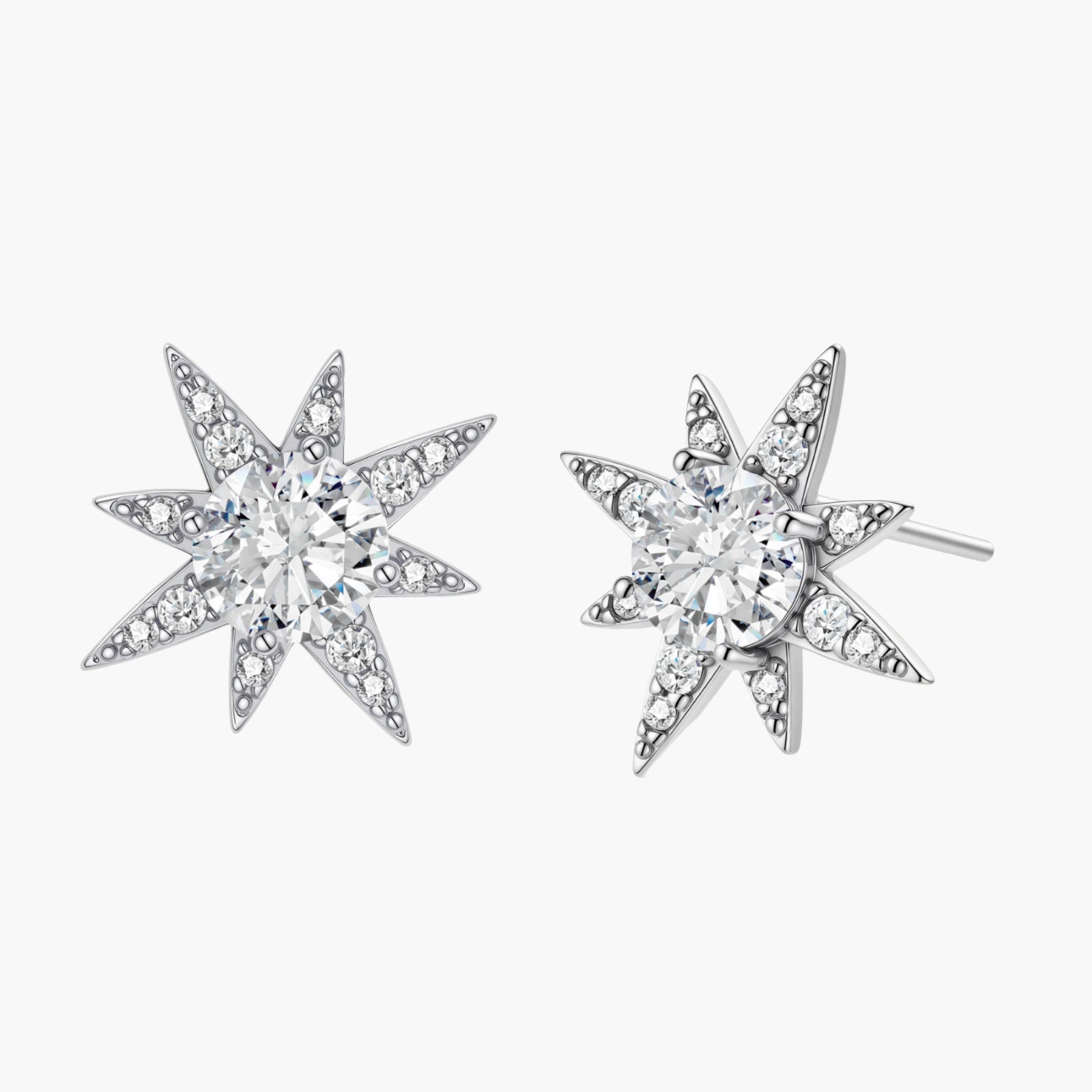 Sterling silver star-shaped stud earrings with brilliant moissanite center stones and pavé details on neutral background.