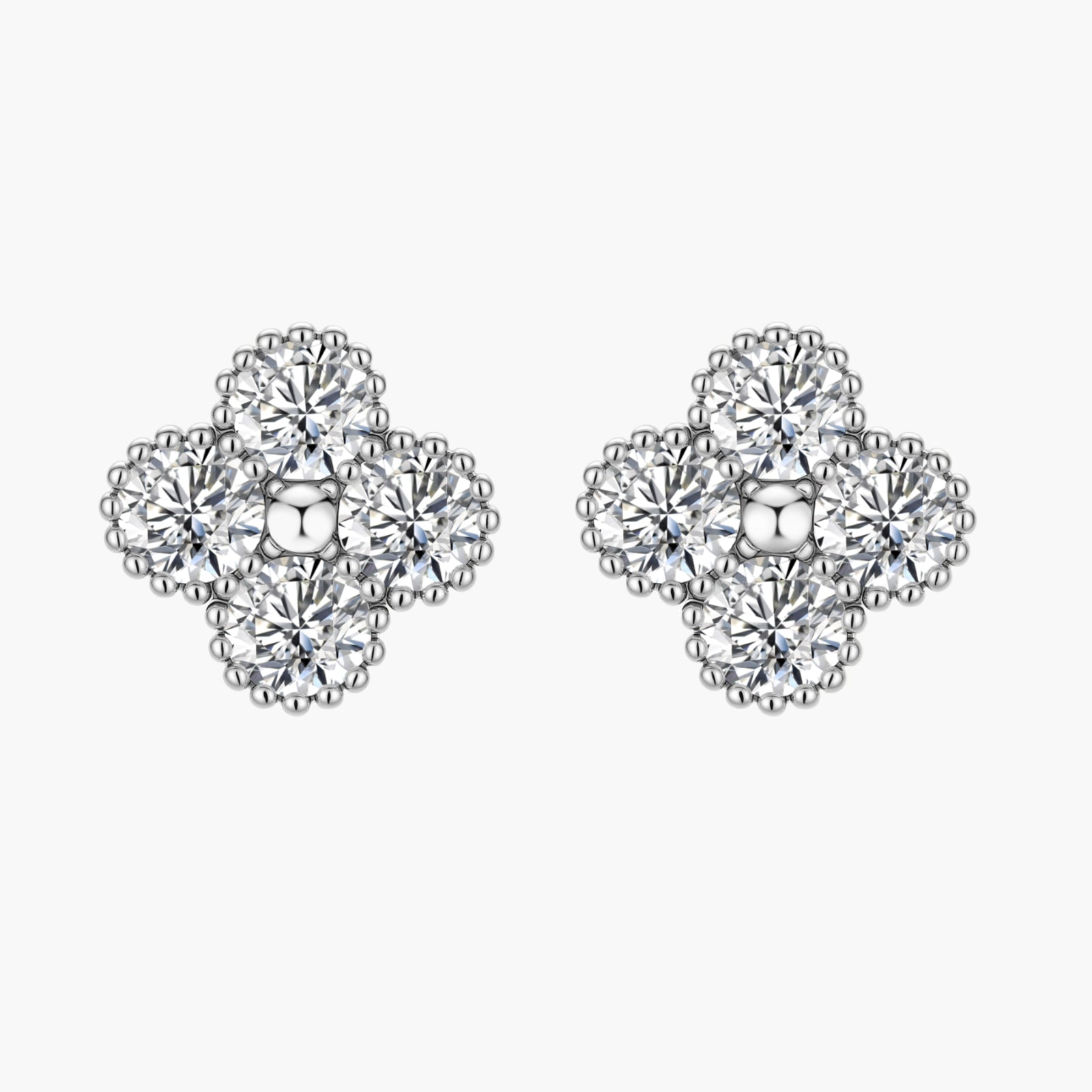 Dainty sterling silver quatrefoil stud earrings with four brilliant moissanite stones and center accent on white background.