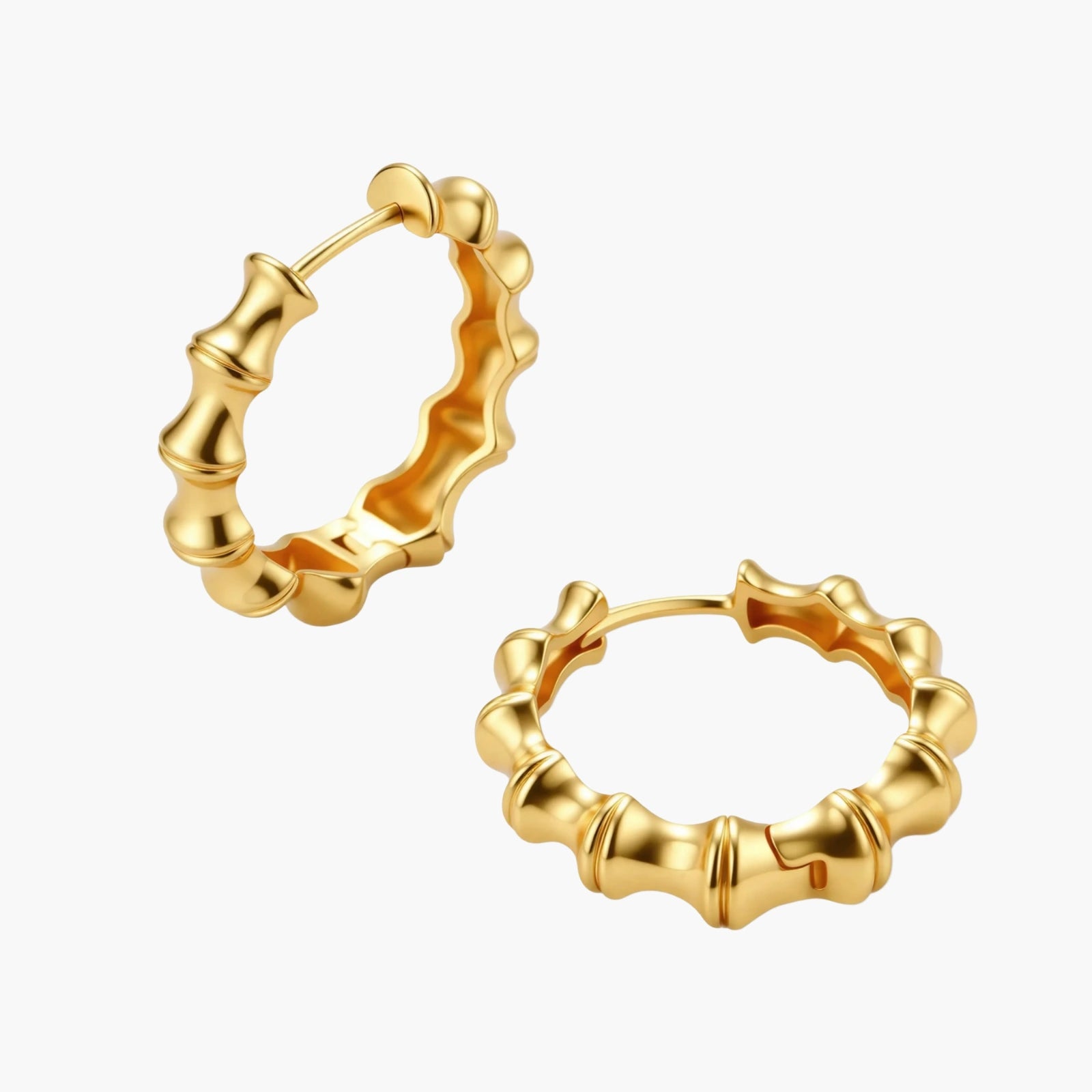 Close-up of gold-plated sterling silver hoop earrings with bamboo-inspired segmented design on white background.
