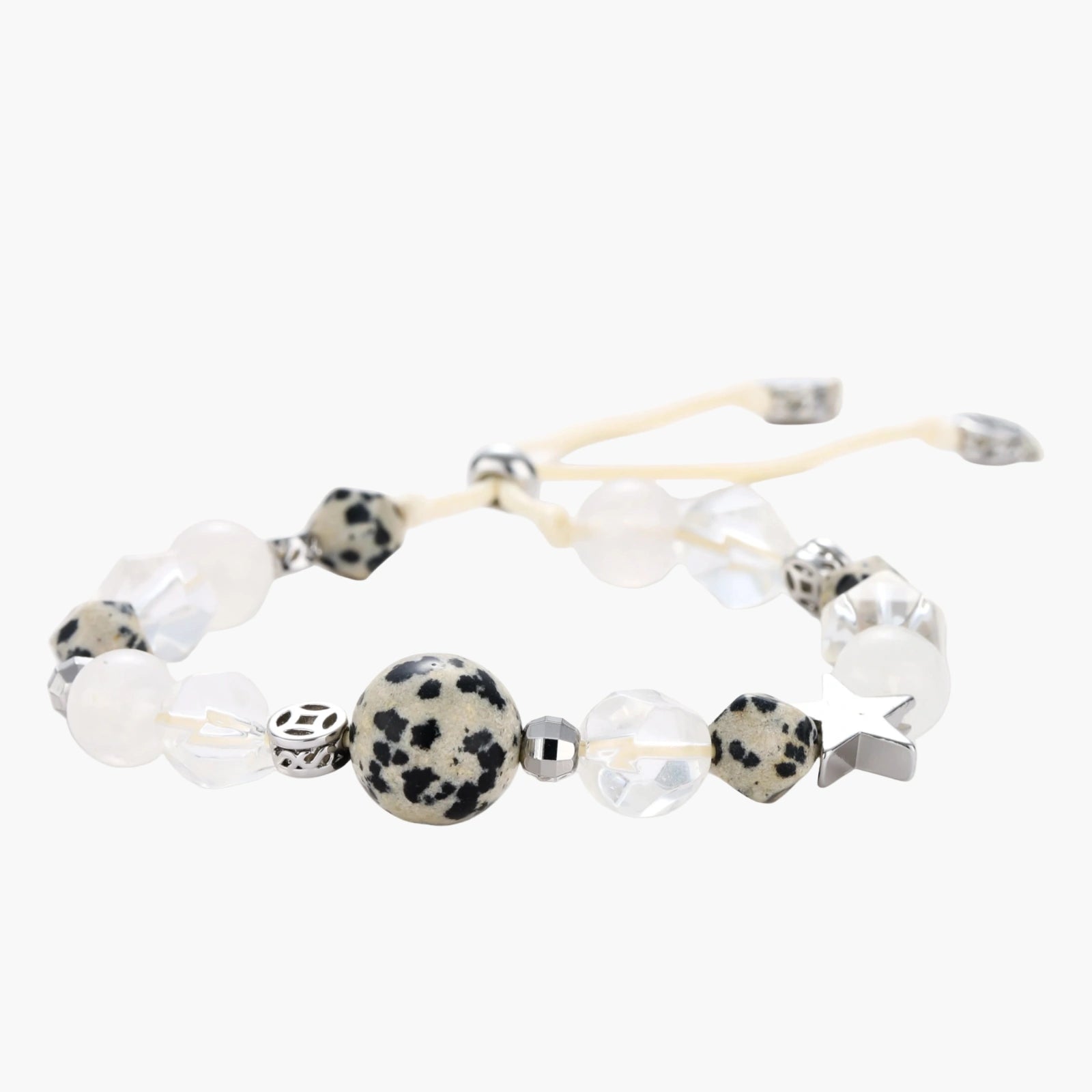 Adjustable beaded bracelet with spotted dalmatian stones, clear quartz crystals, and silver star charm on white background.