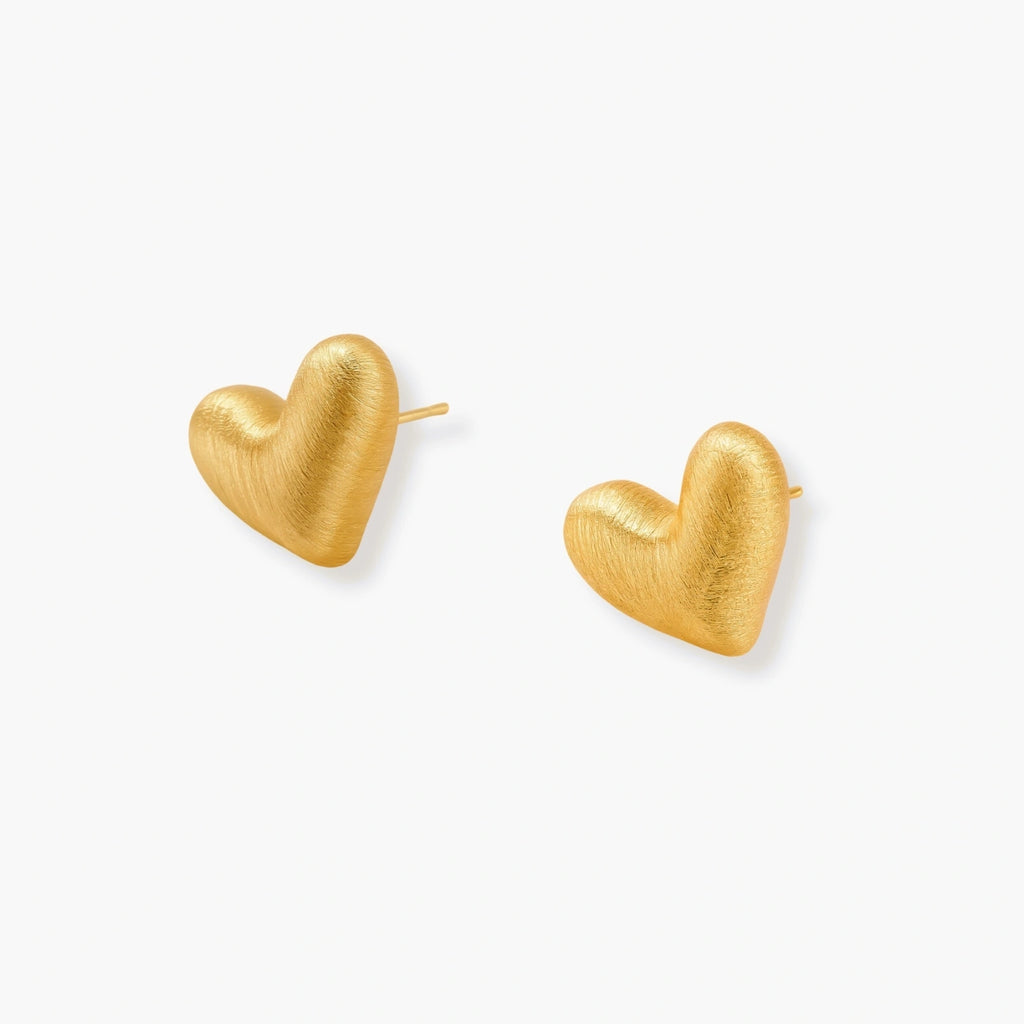 Pair of small heart-shaped stud earrings with brushed metallic finish, showing both silver and gold variants on neutral background.