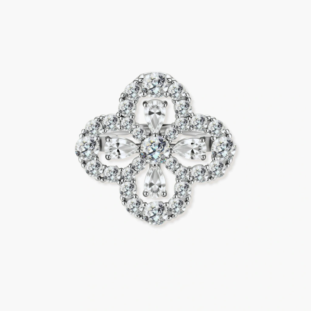 Adjustable sterling silver ring with quatrefoil design featuring brilliant moissanite stones in clover pattern