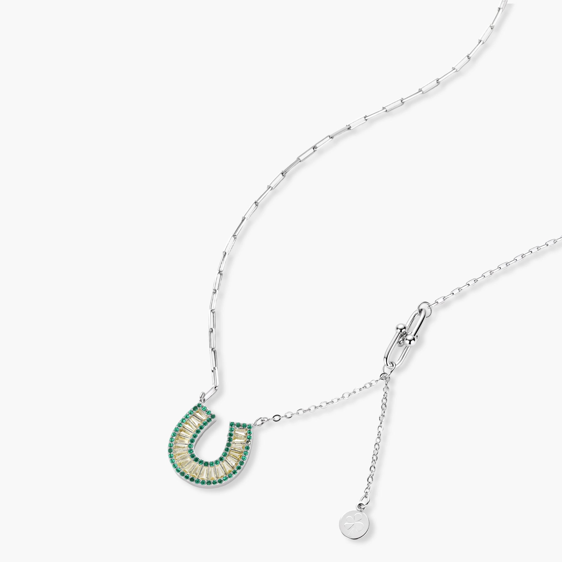 Sparkling horseshoe-shaped jewelry set with AAA cubic zirconia in gold-plated and white gold finishes on cream background.