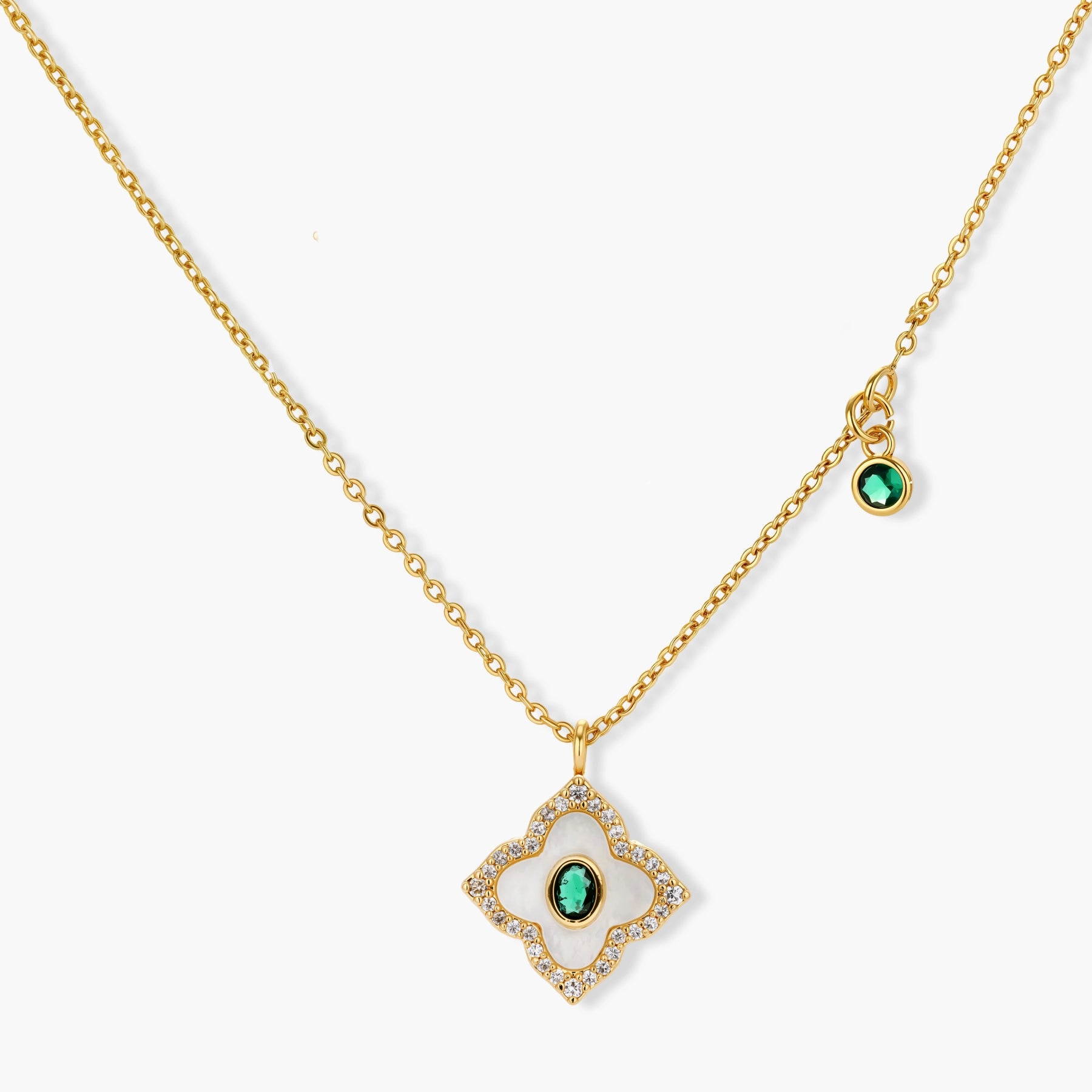 Gold-plated jewelry set with diamond-shaped pendants featuring white centers, green stones, and sparkling zirconia borders