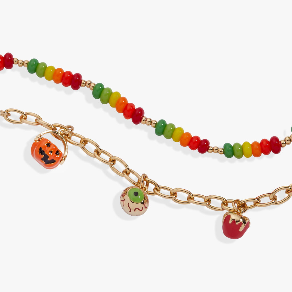 Bracelet with colorful beads and Halloween-themed charms on a white background